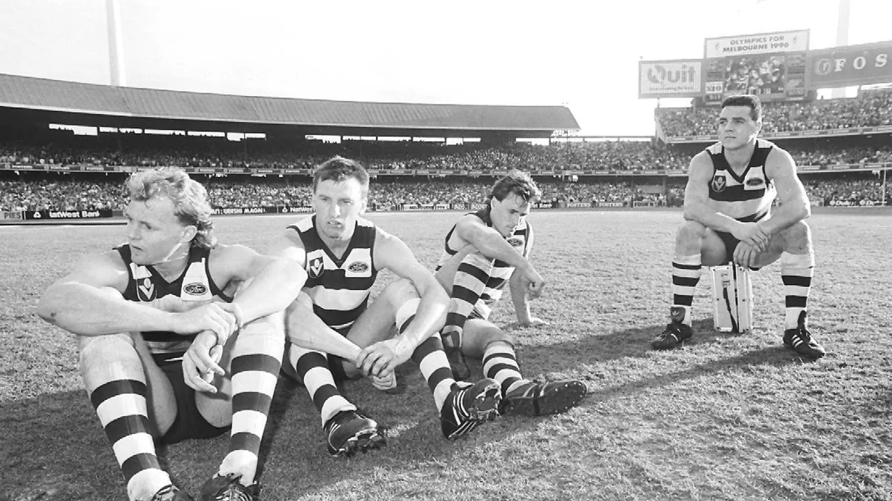 footy players sitting on the field